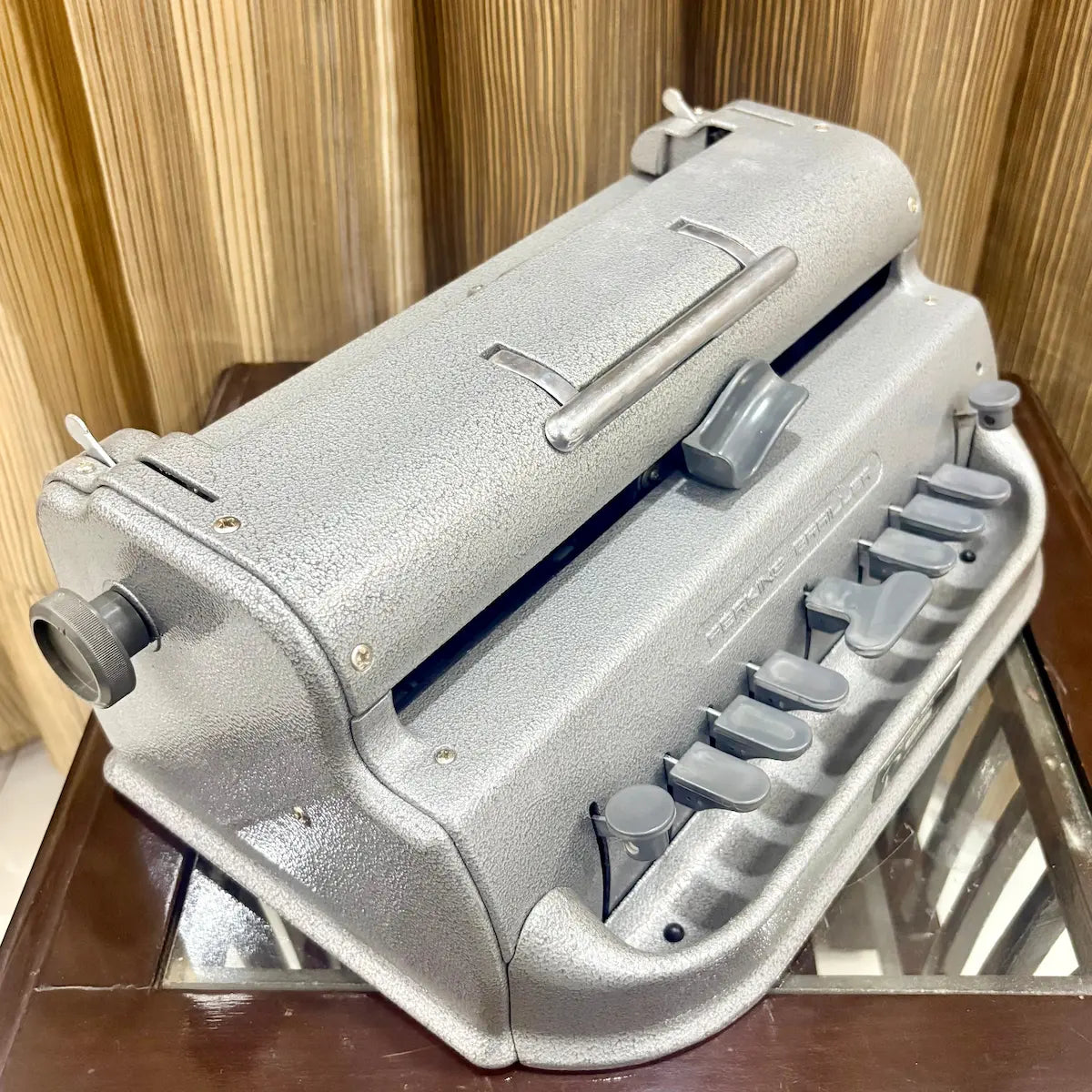 Underside detail of the mint grey Perkins Braille writing machine showing its base at RR Typewriter Mart for Braille users in India.