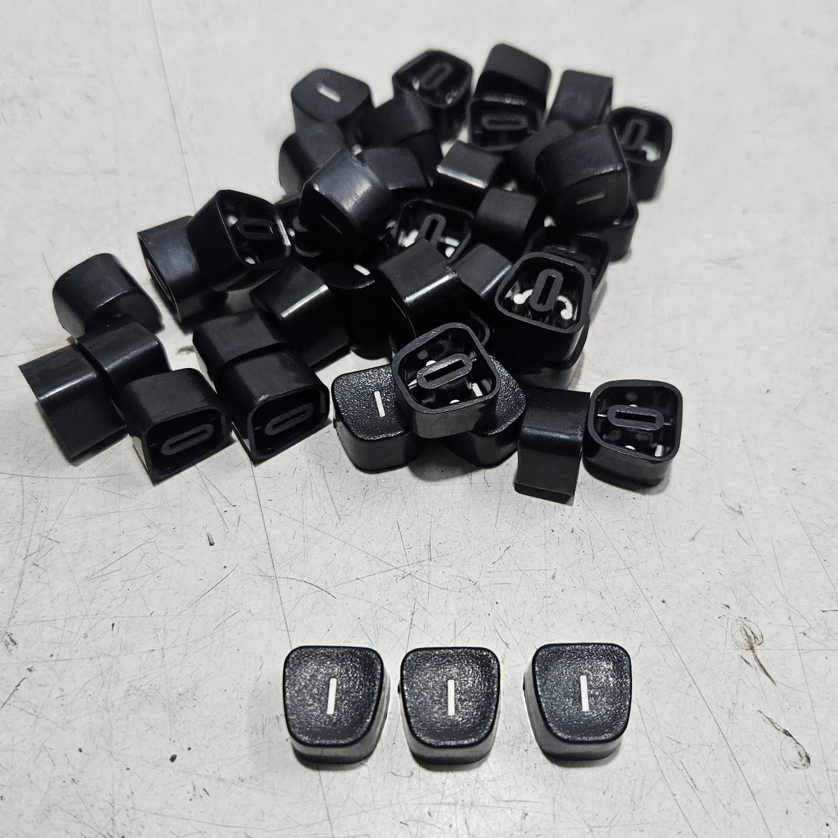 Replacement I keytops for manual typewriters, typing machine servicing parts and restoration components displayed