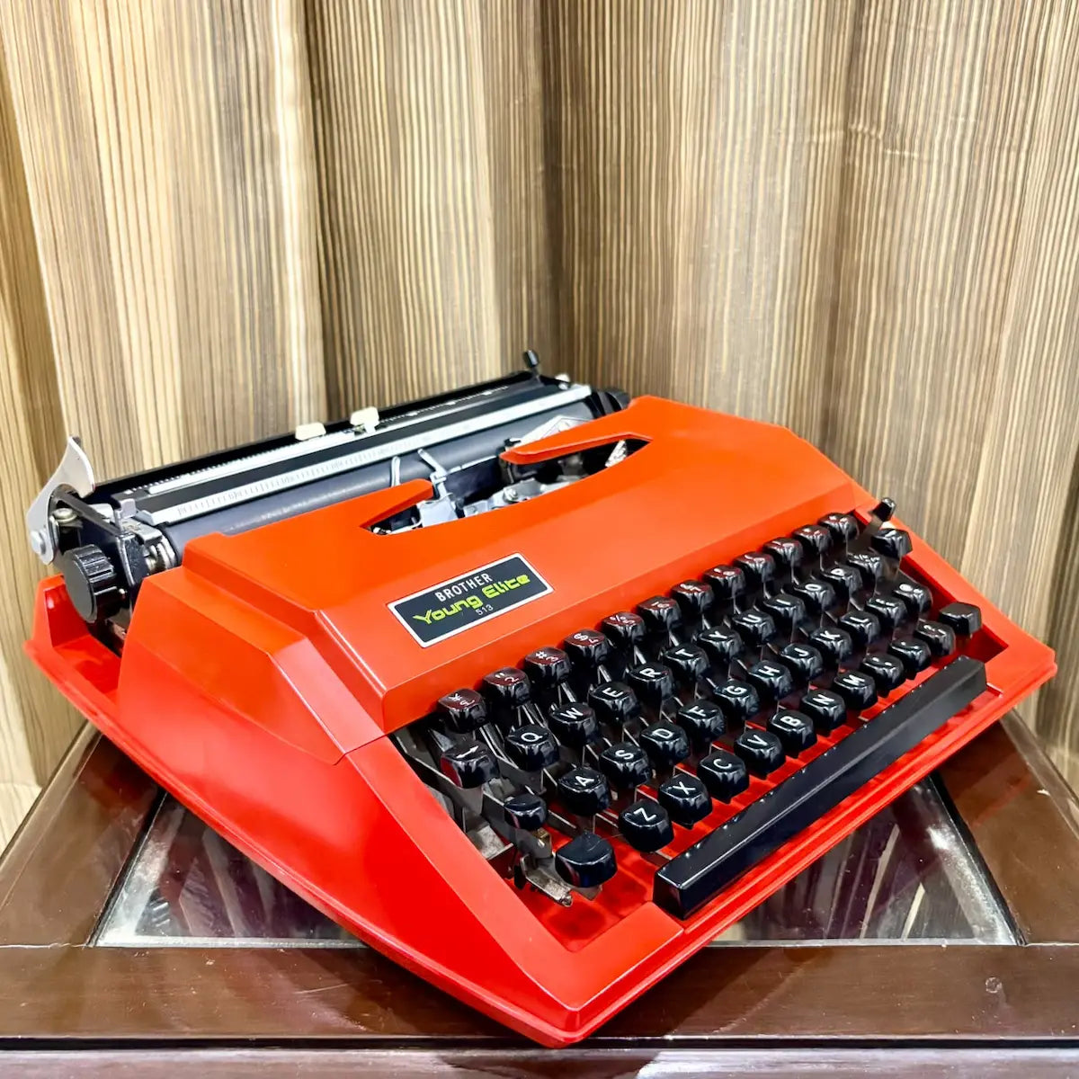 Close-up of Brother Young Elite 513 typewriter keyboard, black English QWERTY keys on an original scarlet red body | RR Typewriter Mart