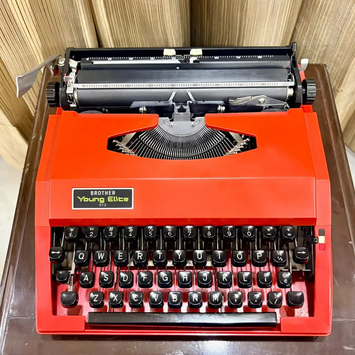 Front close-up of Brother Young Elite 513 red portable typewriter, black keys and original colour finish for collectors | RR Typewriter Mart