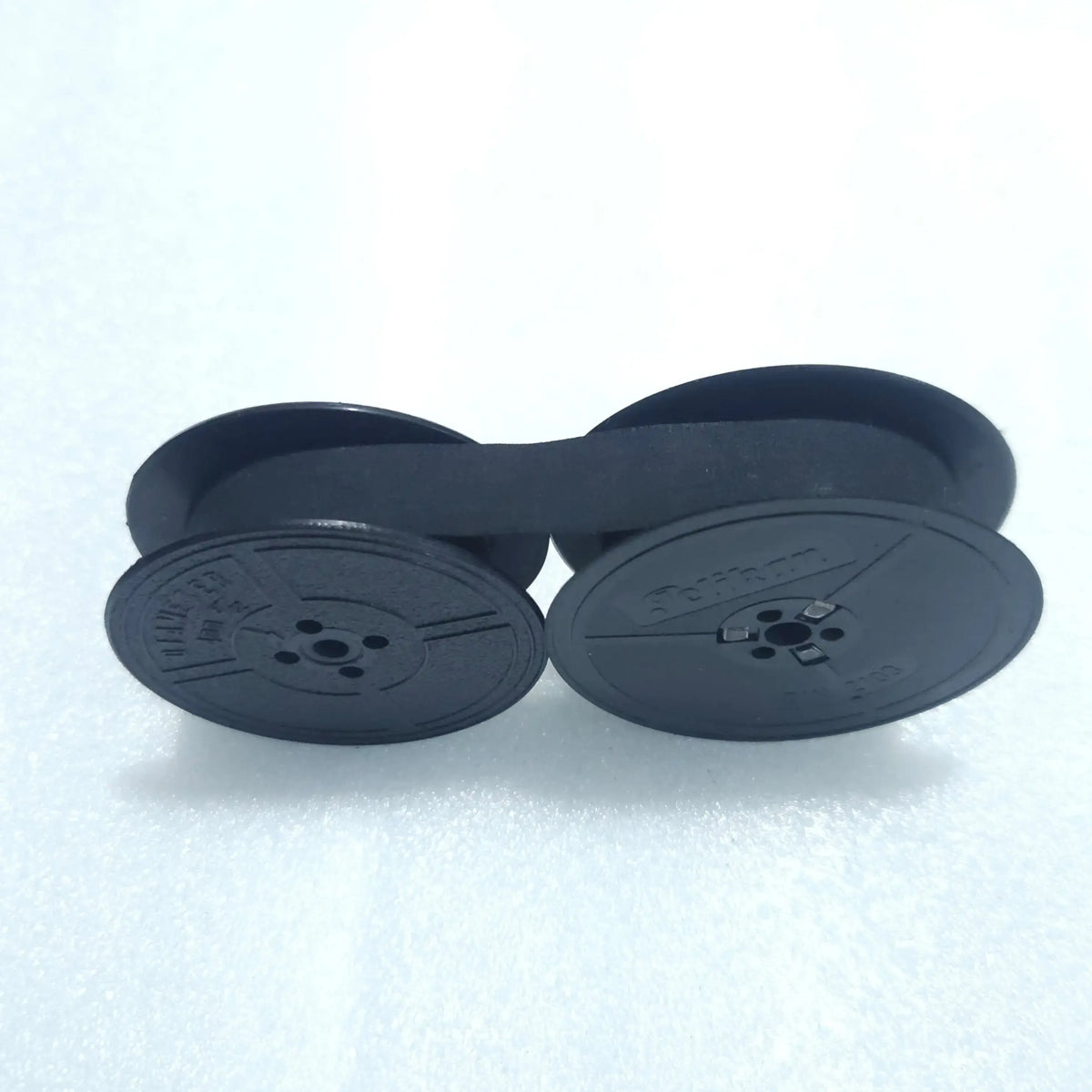 Black typewriter ribbon roll mounted on twin spools, RR Typewriter Mart typewriter ribbon seller
