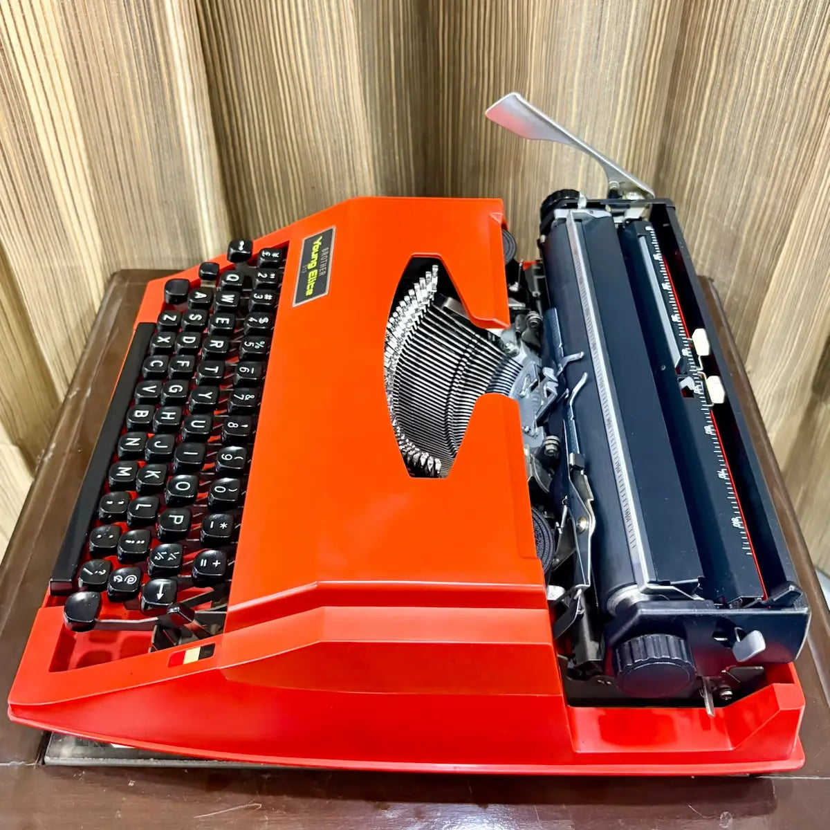 Brother Young Elite 513 red typewriter, detailed view of rear body panel and underside features on a vintage manual machine | RR Typewriter Mart
