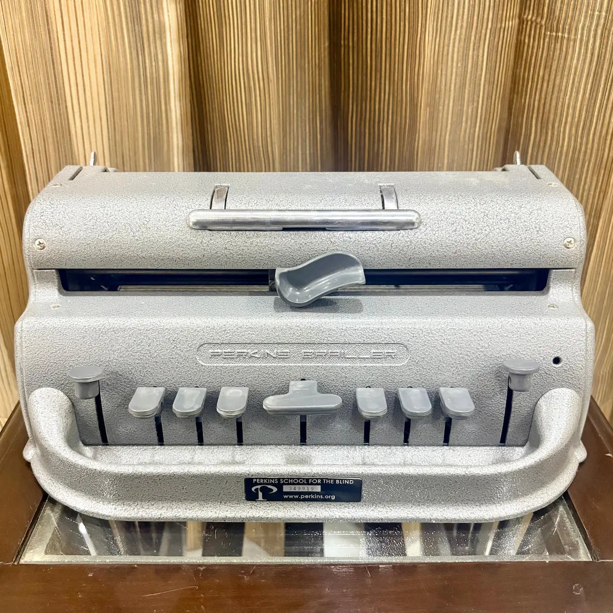 Front view of the Perkins Brailler showing six Braille keys, space bar and grey finish at RR Typewriter Mart for Braille users across India.