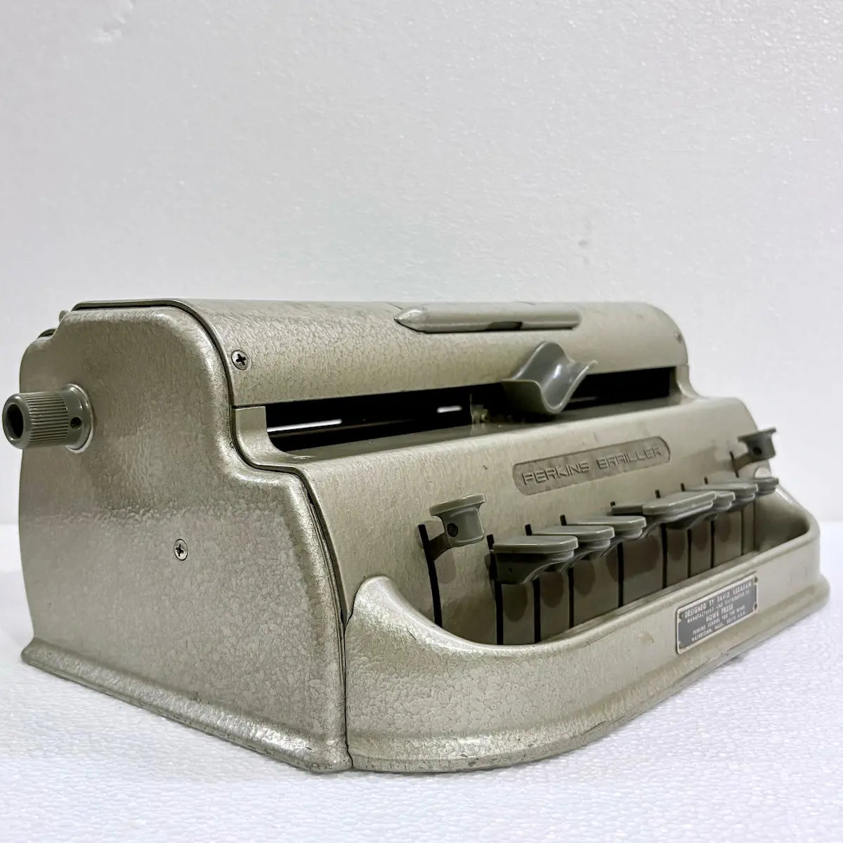 Perkins Braille Typewriter for Braille literacy, featuring a classic metal body and original gold-like finish from RR Typewriter Mart