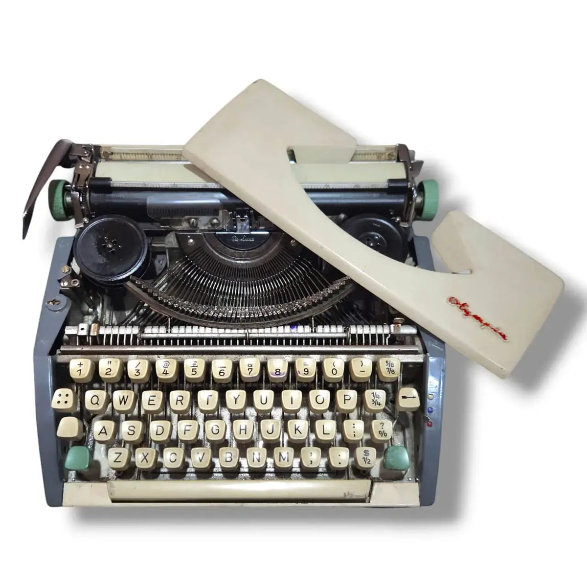 Olympia portable typewriter with cover removed showing internal typing machine mechanics and typebars