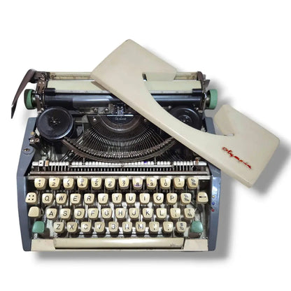 Olympia portable typewriter with cover removed showing internal typing machine mechanics and typebars