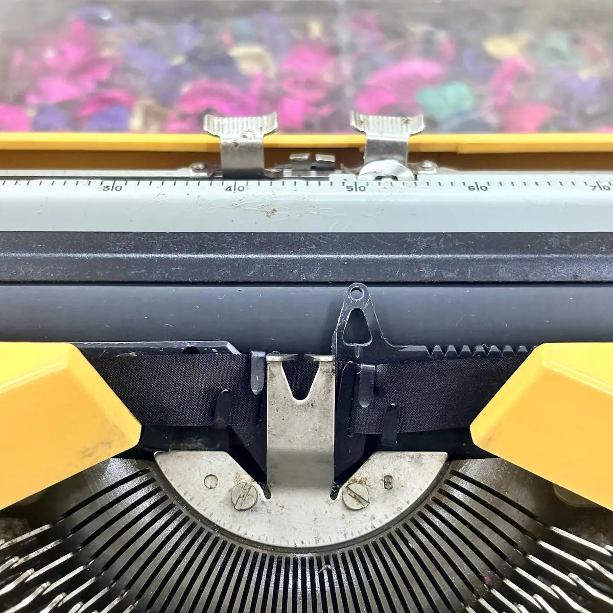 Top view of yellow Olivetti Lettera 82 typewriter showing English keyboard and typebar basket at RR Typewriter Mart