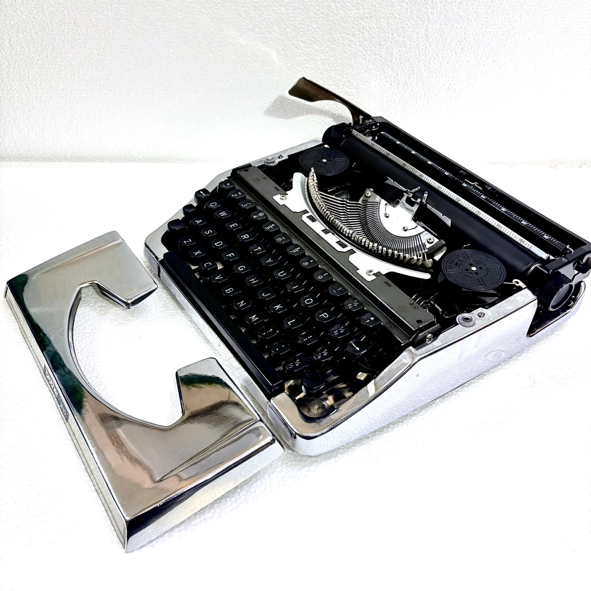Brother 210 portable typing machine with reflective chrome body and black keys from RR Typewriter Mart India
