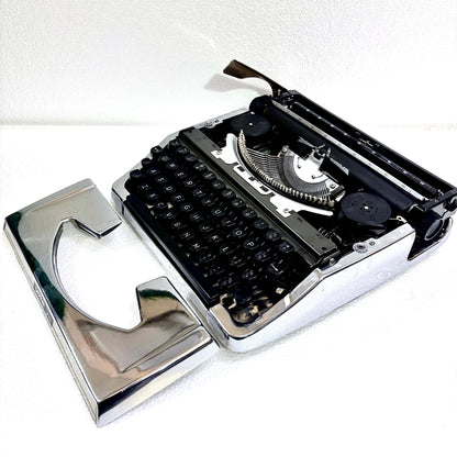 Brother 210 portable typing machine with reflective chrome body and black keys from RR Typewriter Mart India