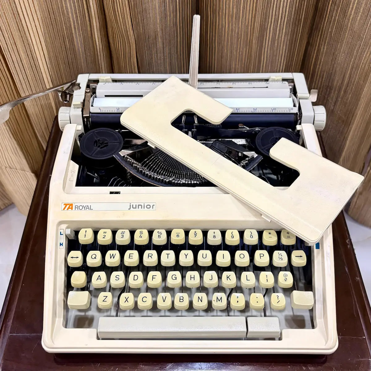 Royal Junior manual typewriter with ribbon area exposed, showing mechanical typing system, from RR Typewriter Mart.