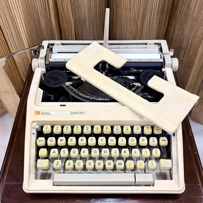 Royal Junior manual typewriter with ribbon area exposed, showing mechanical typing system, from RR Typewriter Mart.
