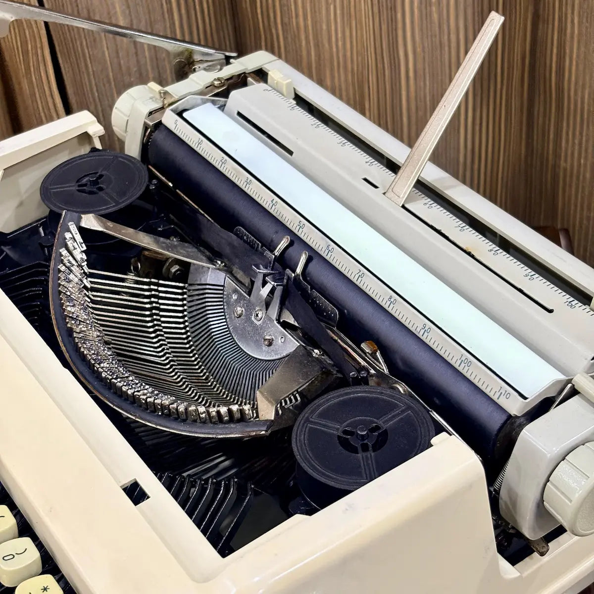 Royal Junior typing machine close-up showing carriage rail, platen and exposed typebars, from RR Typewriter Mart.