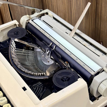 Royal Junior typing machine close-up showing carriage rail, platen and exposed typebars, from RR Typewriter Mart.