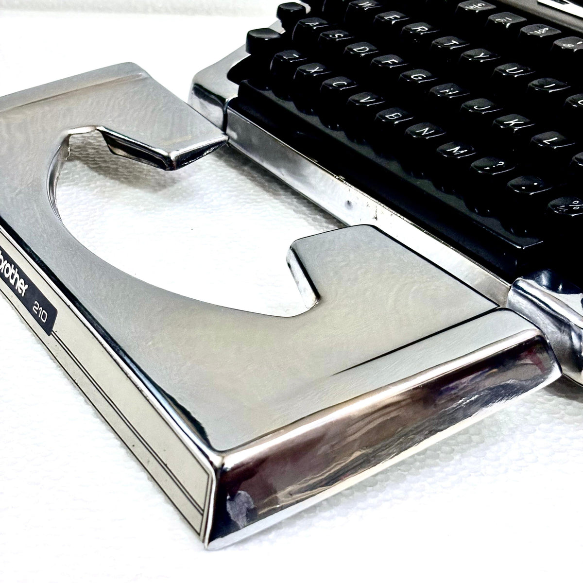 Brother 210 vintage typewriter with mirror chrome body, manual English keyboard and black keys from RR India