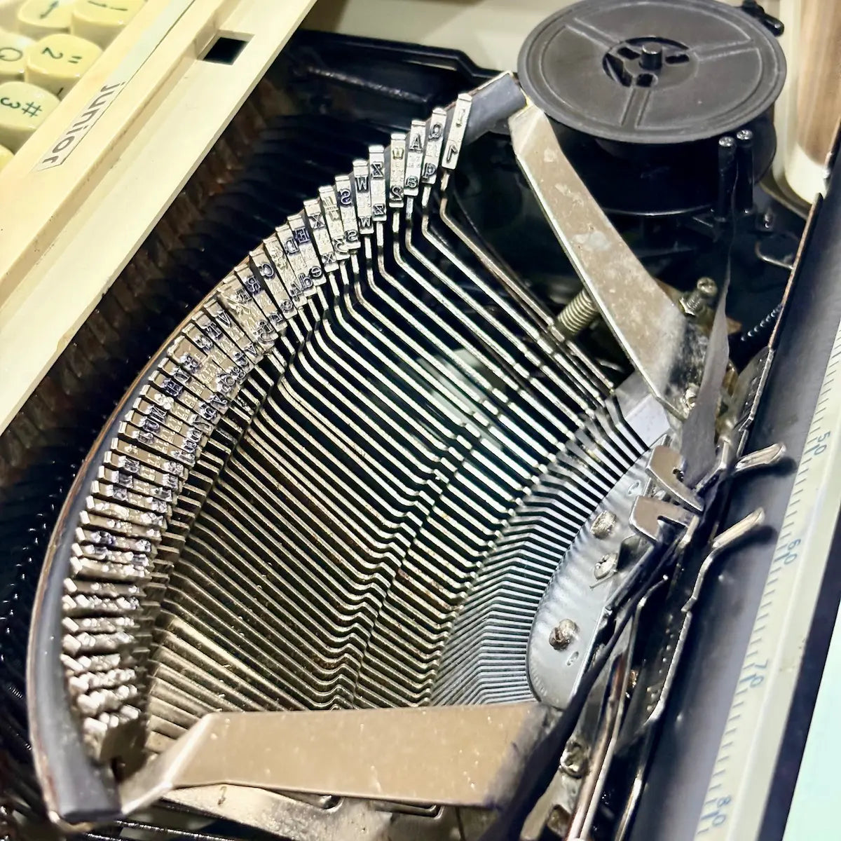 Royal Junior manual typewriter close-up of typebars, ribbon area and mechanical mechanism, from RR Typewriter Mart.