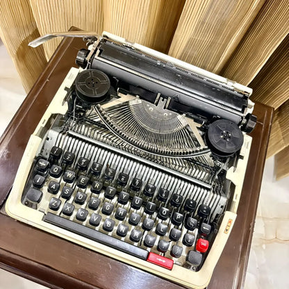 Clover 1200 TF cream manual typewriter, compact portable typing machine with black keys and red accents