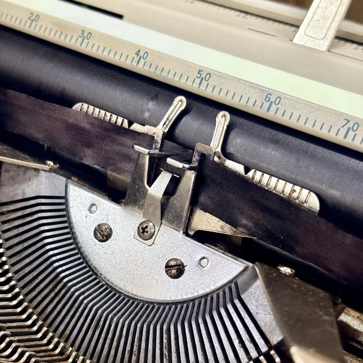 Royal Junior typing machine close-up showing carriage mechanism, platen and ribbon assembly, from RR Typewriter Mart.
