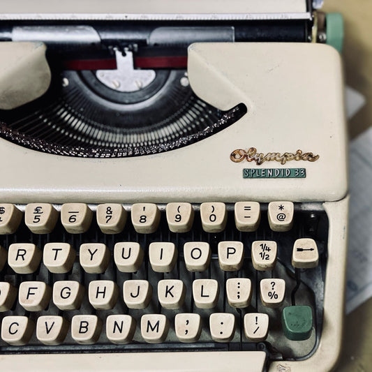 Olympia Splendid 33 portable typewriter close-up, vintage manual typing machine with QWERTY keyboard