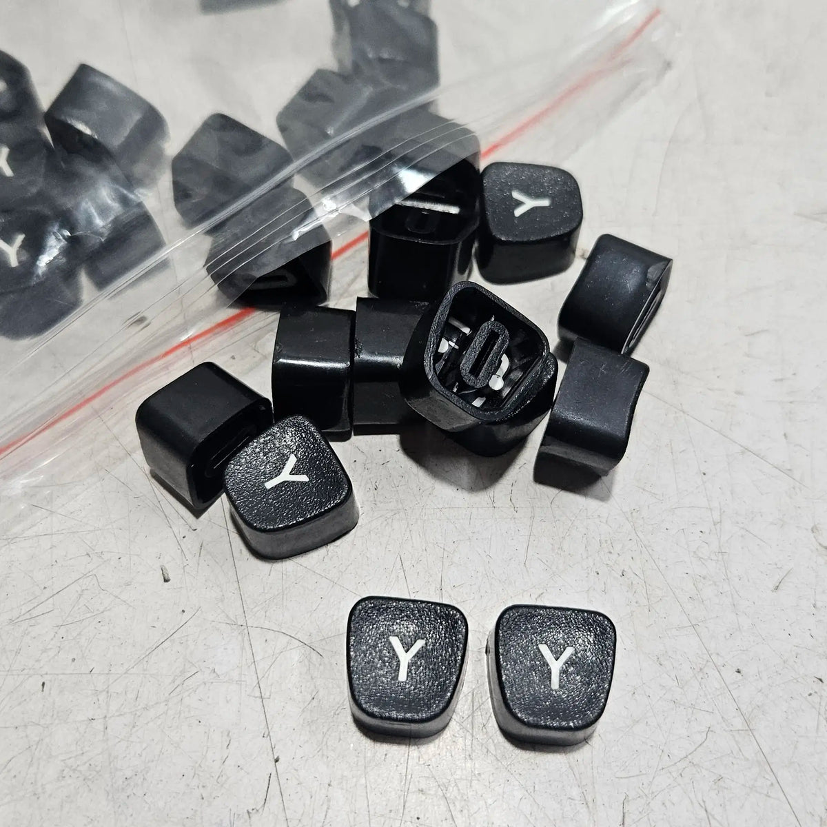 Black Godrej Y keytops displayed on a worktable, typing machine spare parts for manual typewriter repair work
