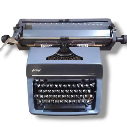 Godrej English typewriter front view with grey body, round black keys, manual typing machine by RR Typewriter Mart