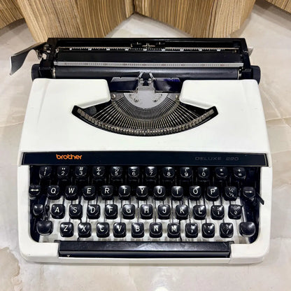 Brother Deluxe 220 Pearl White typewriter showing cream-white body, black keys and traditional mechanical typing mechanism in India