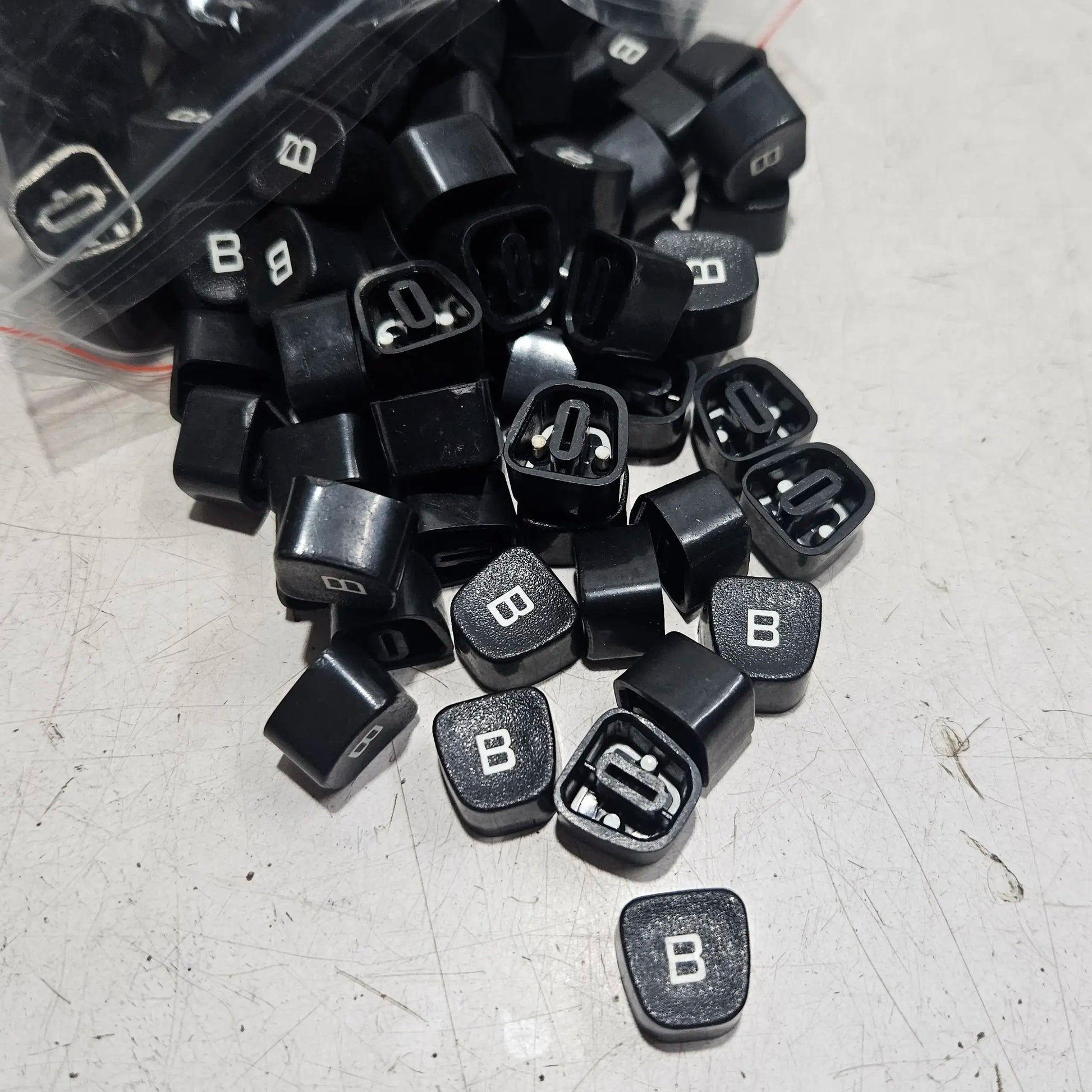 Close view of black Godrej B keytops used for typewriter restoration and typing machine maintenance work