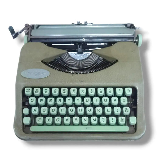 Hermes Baby Rocket manual English typewriter front view, Swiss portable typing machine with mint green keyboard