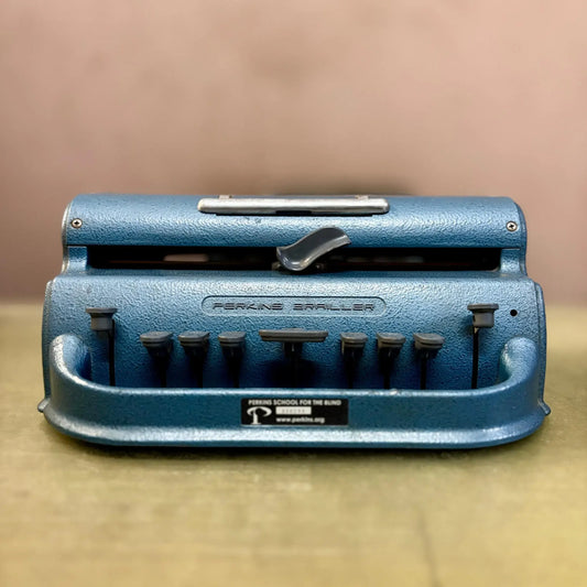 Front view of blue Perkins Braille Typewriter, manual braille typing machine from RR Typewriter Mart braille store