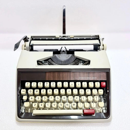 Front view of Brother portable English typewriter with repeat spacer keys by RR Typewriter Mart, trusted typewriter seller