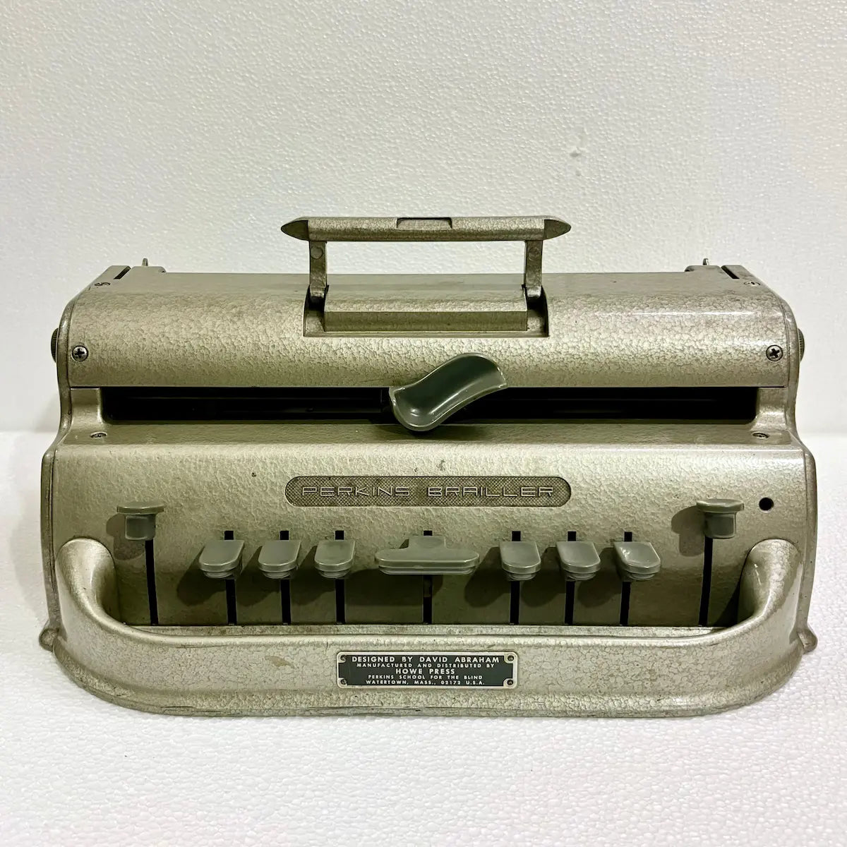 Original American-imported Perkins Braille Typewriter in gold-toned factory finish, a manual Braille writing machine from RR Typewriter Mart