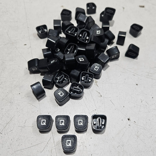 Close view of black Q typewriter keytops used in typewriter restoration and typing machine maintenance projects