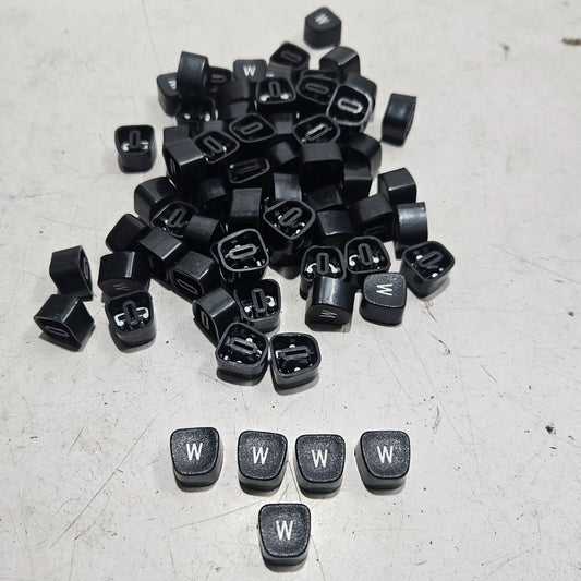 Close view of black W typewriter keytops used in typewriter restoration and typing machine maintenance projects