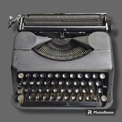 Vintage Hermes Baby Rocket manual typewriter front view with round keys, compact body and exposed typebars