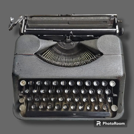 Vintage Hermes Baby Rocket manual typewriter front view with round keys, compact body and exposed typebars