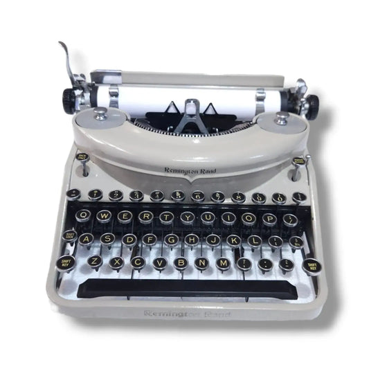 Remington Rand Noiseless manual typewriter front view with cream body, round black keys and classic American design