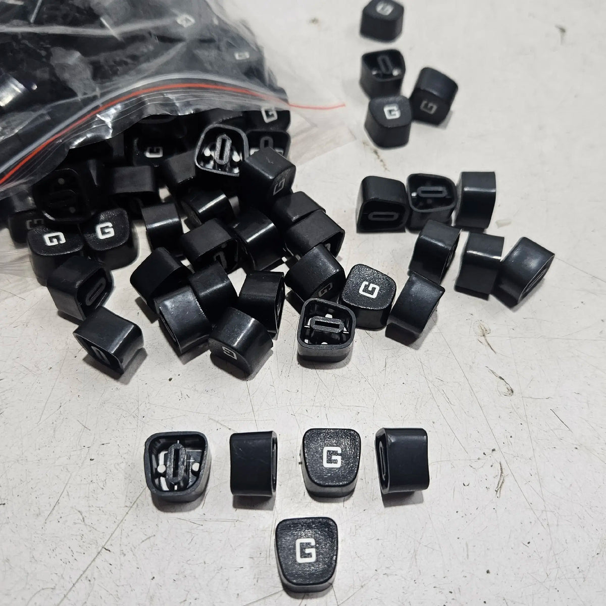 Black Godrej G typewriter keytops displayed on a worktable, manual typewriter parts for repair and restoration