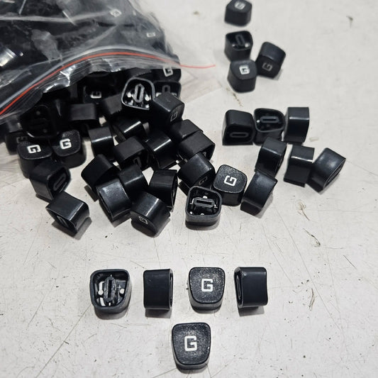 Black Godrej G typewriter keytops displayed on a worktable, manual typewriter parts for repair and restoration
