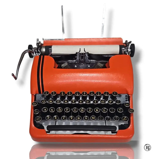 Smith-Corona Sterling Silent orange typewriter front view with black QWERTY keyboard, carriage and round keys