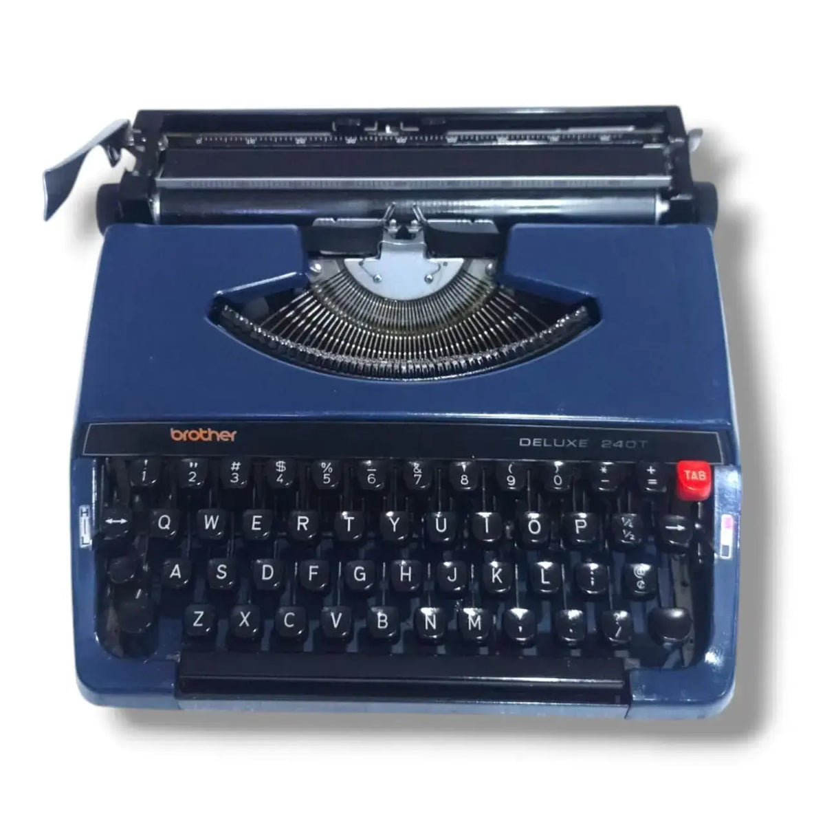 Brother Deluxe 240T typewriter in blue, front view with English keyboard and classic Japanese portable design