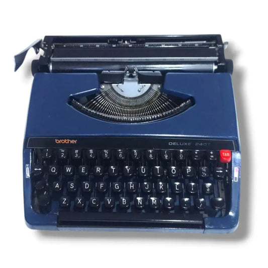 Brother Deluxe 240T typewriter in blue, front view with English keyboard and classic Japanese portable design