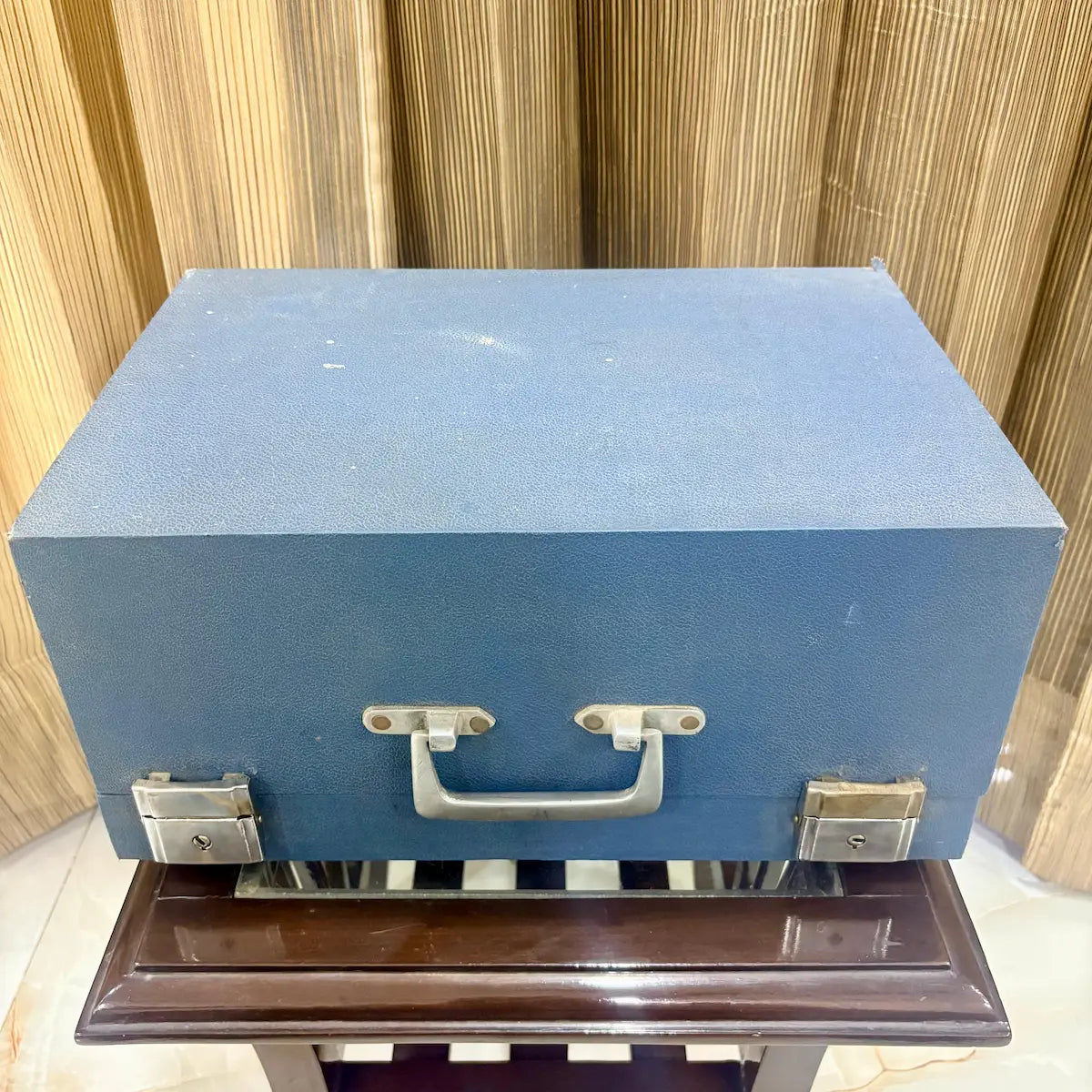 Closed blue wooden case with metal latches for a mint grey Perkins Braille Typewriter at RR Typewriter Mart for Braille users in India.