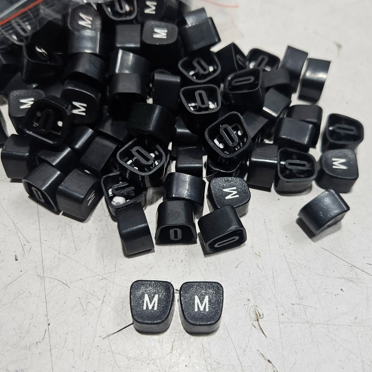 Black Godrej English M typewriter loose keytops for manual typewriter repair, restoration and spare parts replacement