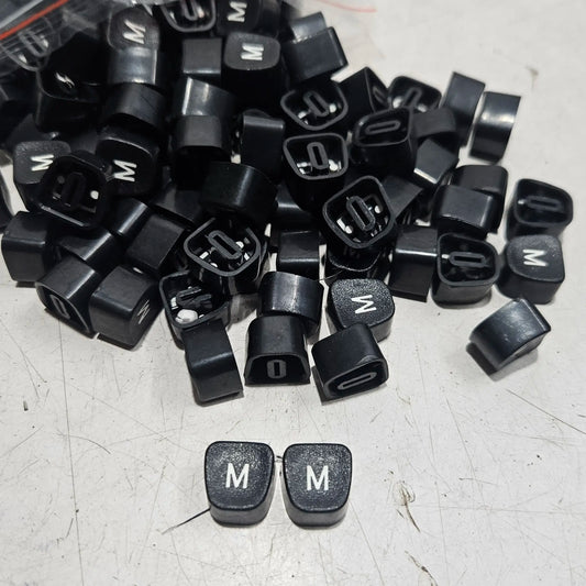 Black Godrej English M typewriter loose keytops for manual typewriter repair, restoration and spare parts replacement