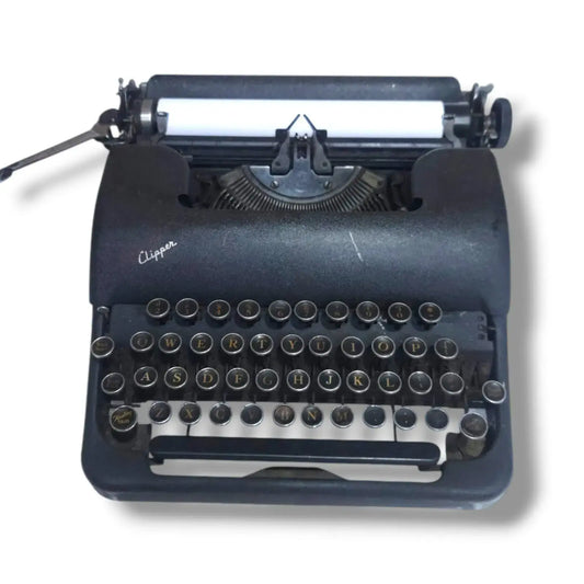 Smith Corona Clipper vintage typewriter front view with black body, round metal keys and classic American design