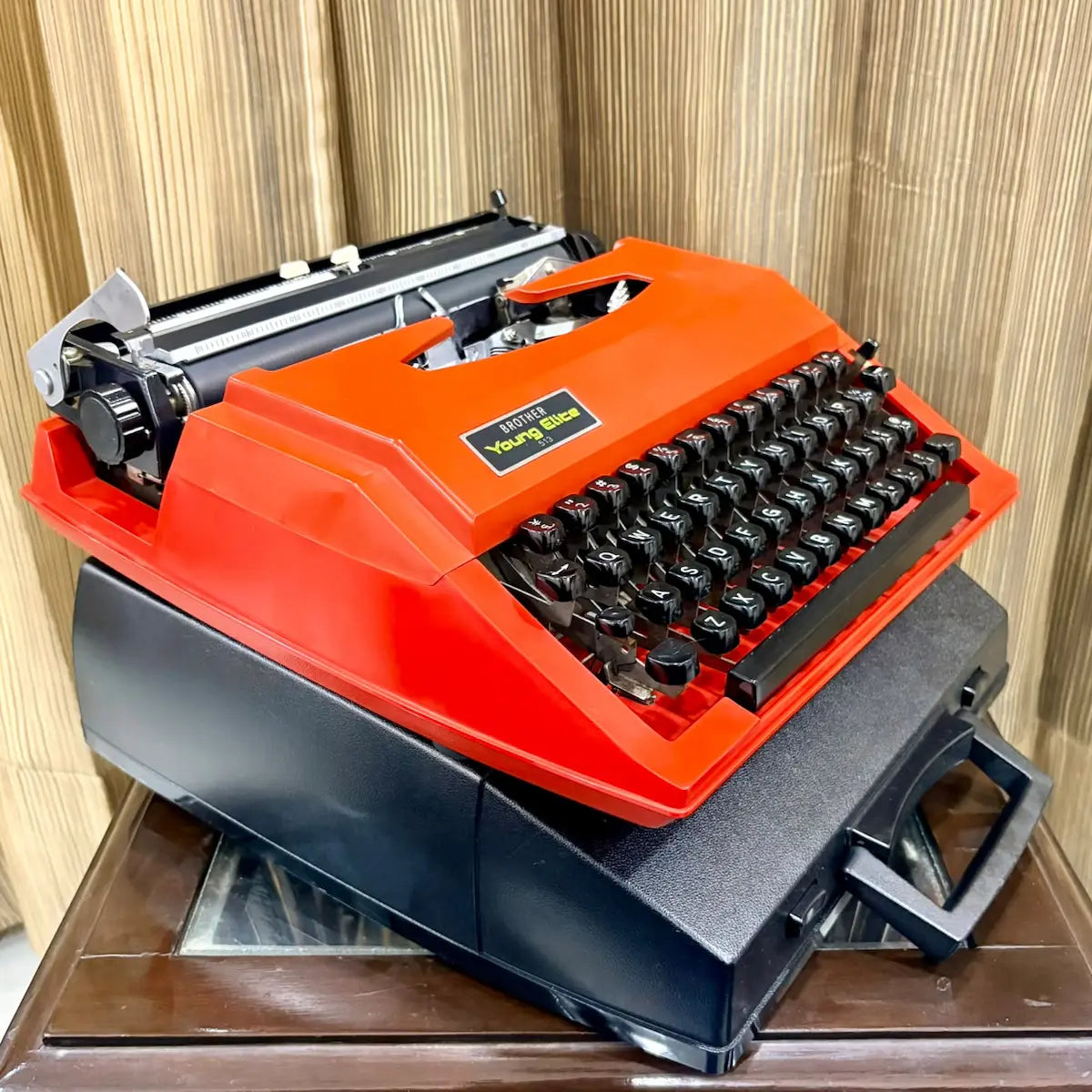 Scarlet red Brother Young Elite 513 portable manual typewriter, angled view showing black keyboard and compact vintage body | RR Typewriter Mart