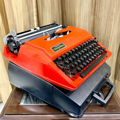 Scarlet red Brother Young Elite 513 portable manual typewriter, angled view showing black keyboard and compact vintage body | RR Typewriter Mart