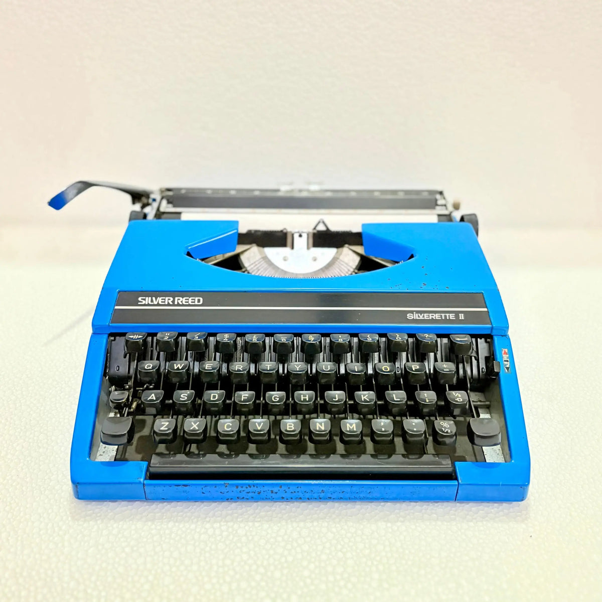 Front view of blue Silver Reed portable manual typewriter with English keyboard, for daily writing at RR Typewriter Mart