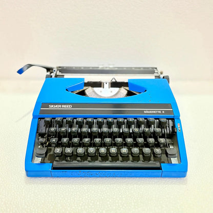 Front view of blue Silver Reed portable manual typewriter with English keyboard, for daily writing at RR Typewriter Mart