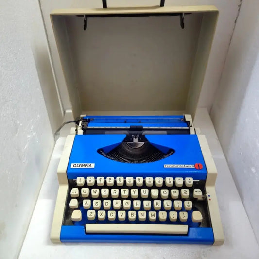 Olympia Traveller De Luxe Blue Voltage portable typewriter with carry case from RR Typewriter Mart