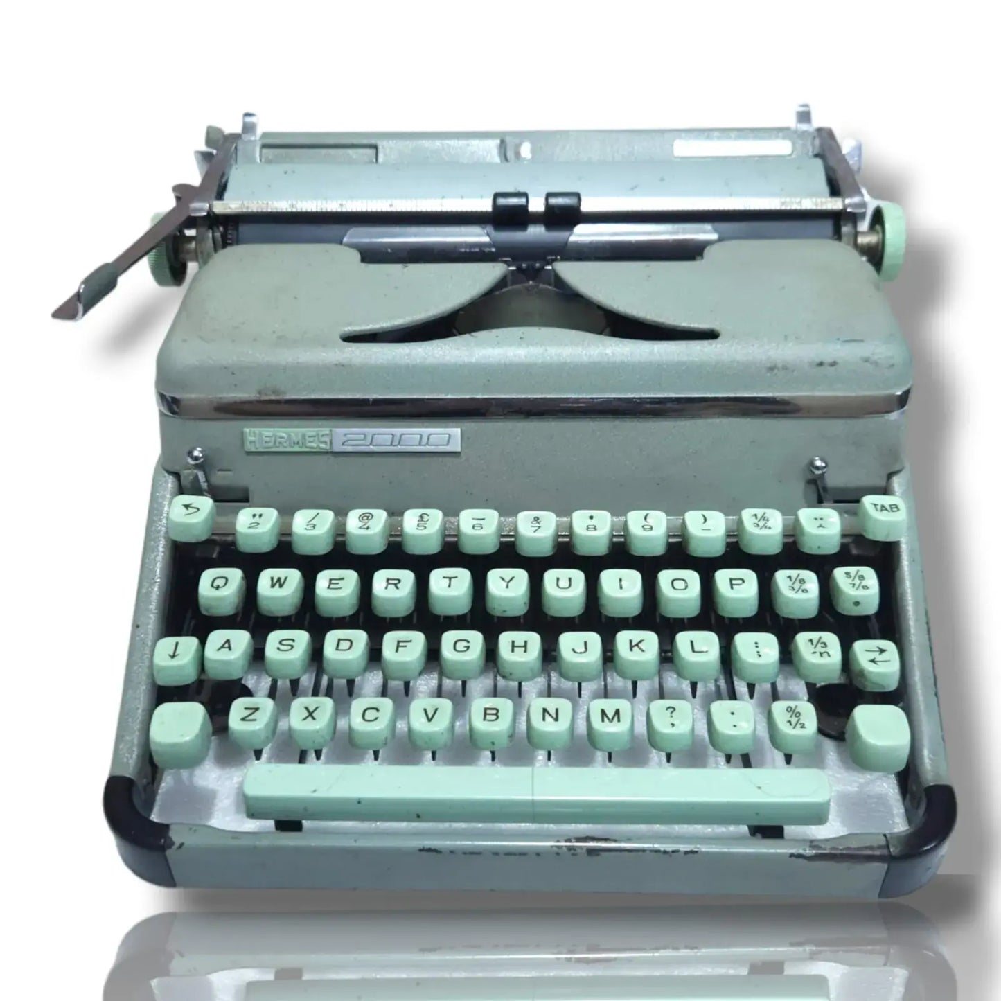 Vintage typewriter with a light green keyboard on a white background